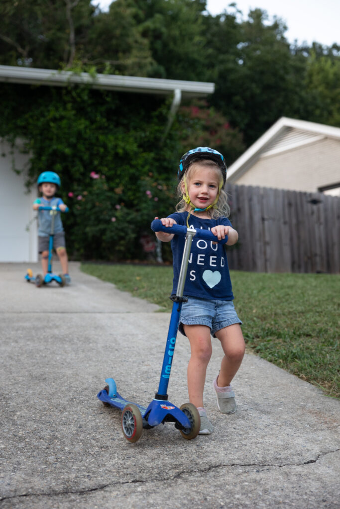 spring family photo ideas capturing real life in raleigh - scooter in the driveway or your neighborhood