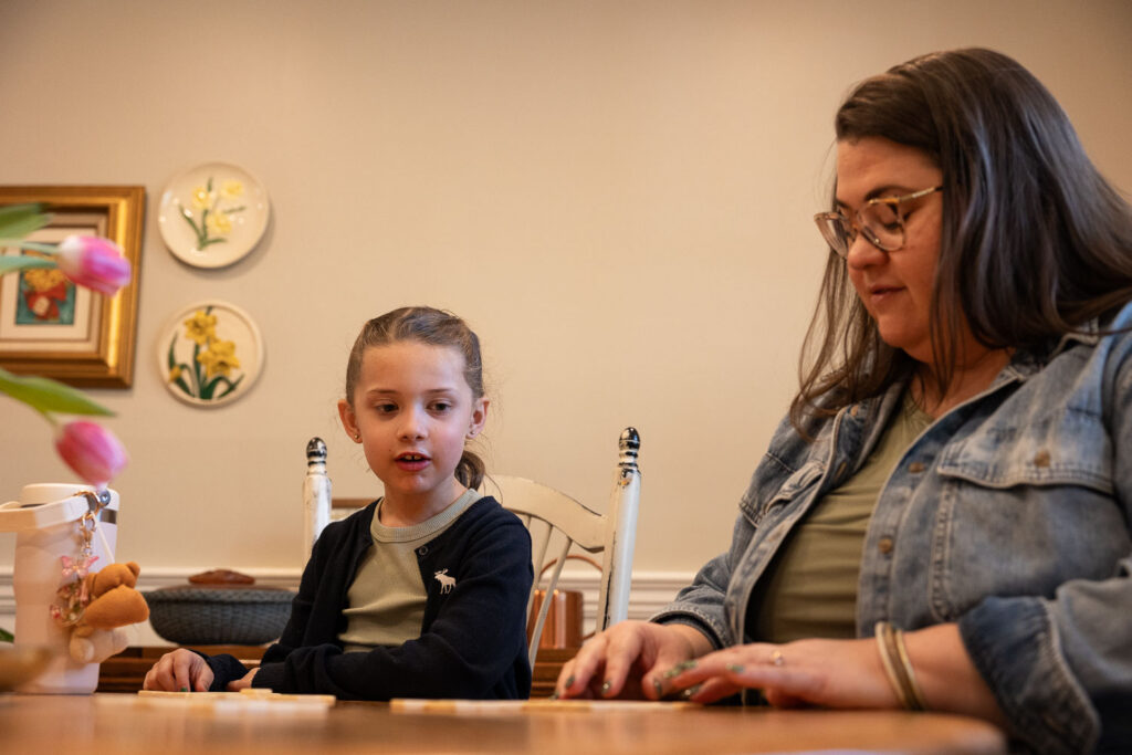 candid documentary family photos in the spring, playing games at home in Raleigh