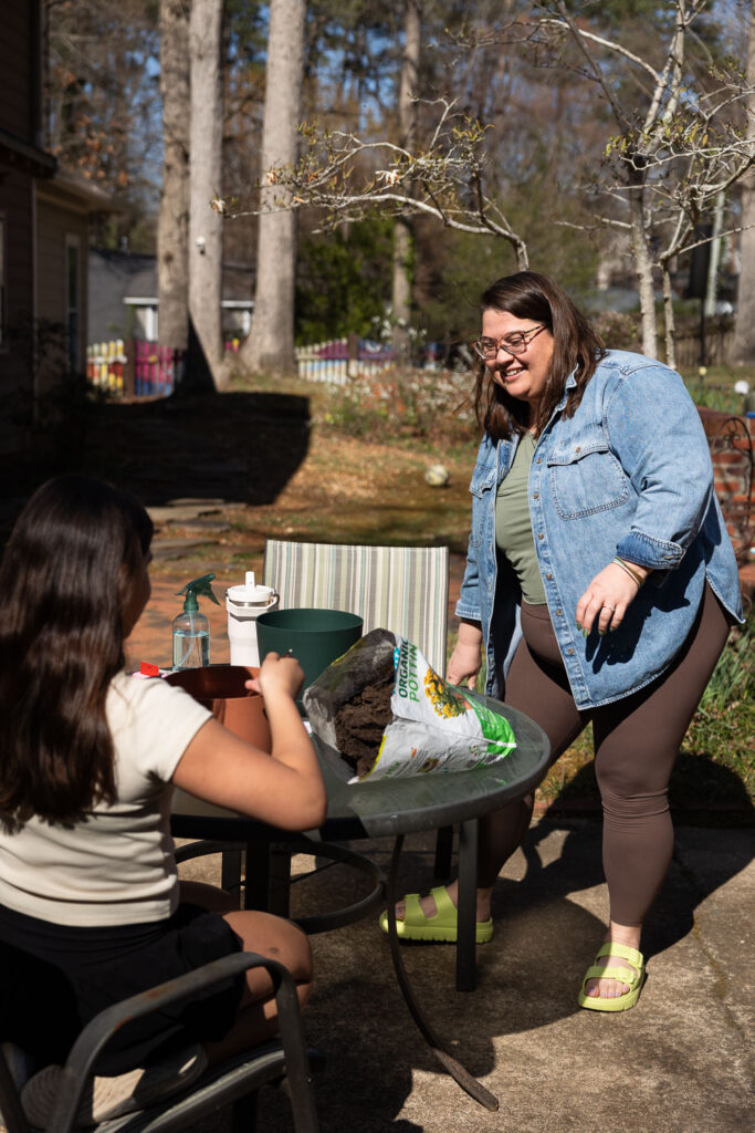 Liz Chavez @liztrullly gardening with her daughters for a Springtime Candid Documentary Family Photo session in Raleigh