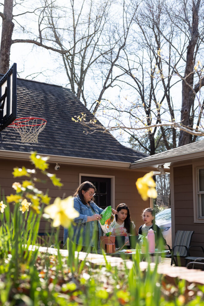 springtime candid documentary family photos in Raleigh planting seeds and gardening at home