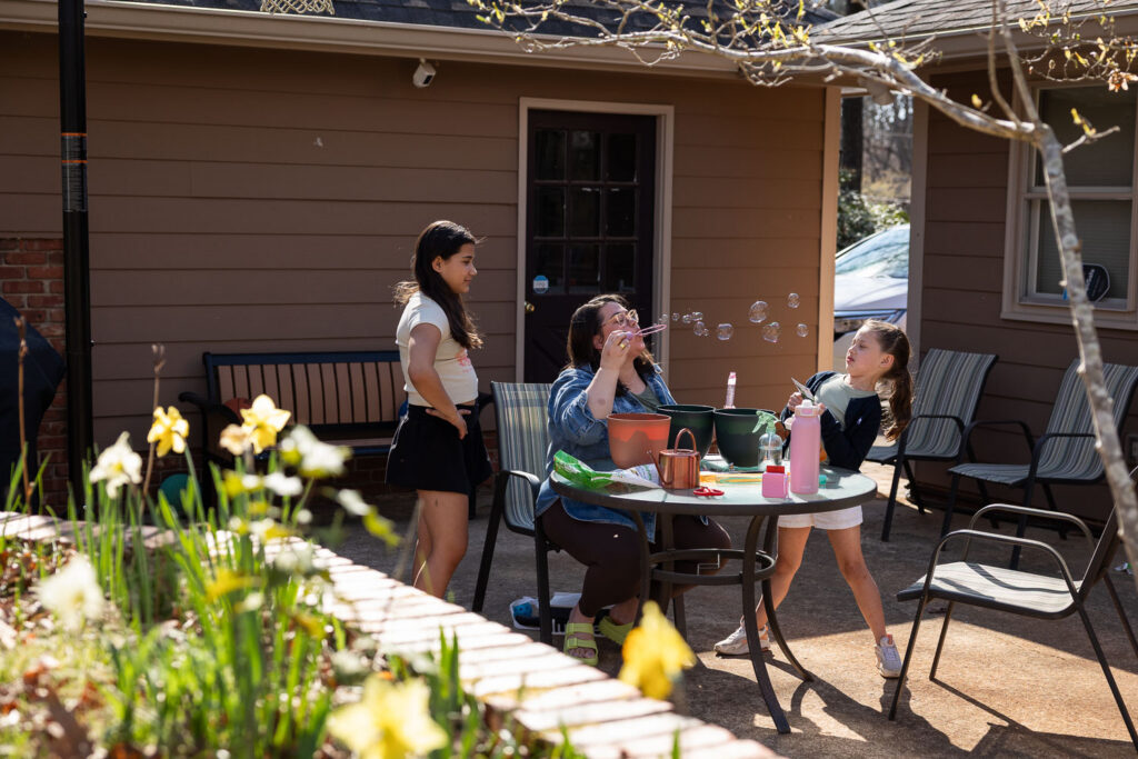 North Hills Raleigh springtime candid documentary family photos blowing bubbles and gardening at home 