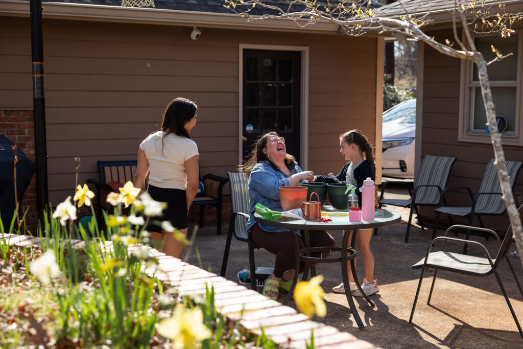 Springtime candid documentary family photos in Raleigh, mom laughing with her daughters