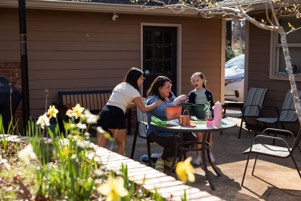 Springtime candid documentary family photos in North Hills Raleigh, mom laughing with her daughters