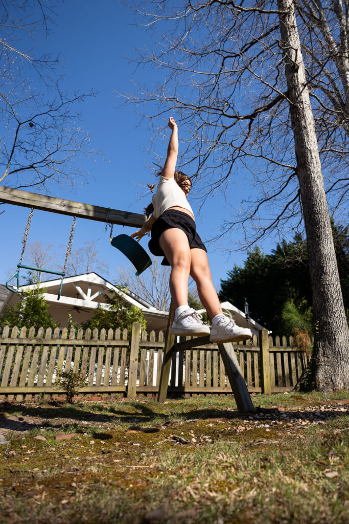 Springtime Candid Documentary Family Photos in Raleigh, real life jumping off a swing in the backyard 