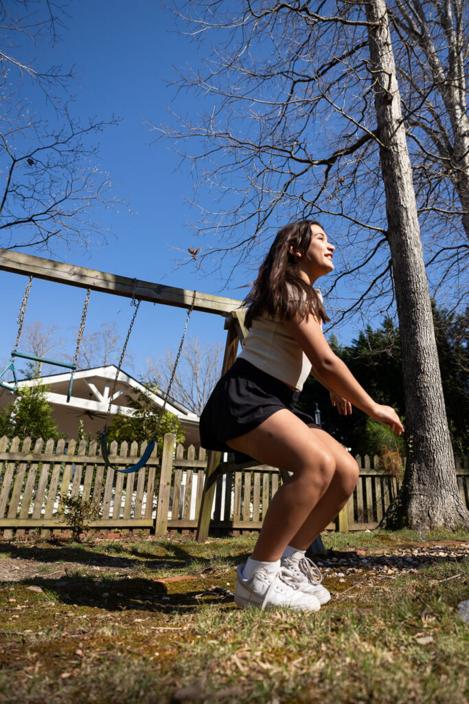 Springtime Candid Documentary Family Photos in Raleigh, landing a jump off a swing in the backyard