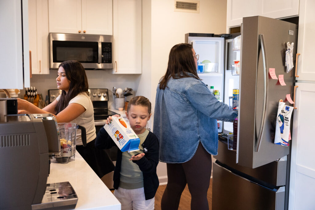Springtime Candid Documentary Family Photos in Raleigh mom and daughters making smoothies together in the kitchen