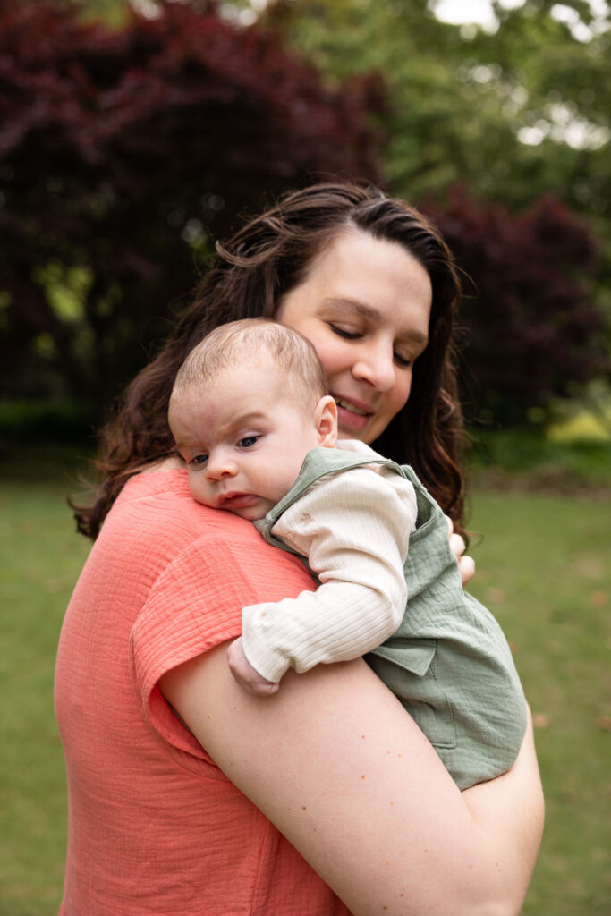 Mom holds 3-month-old baby at one of their baby's first year photo sessions