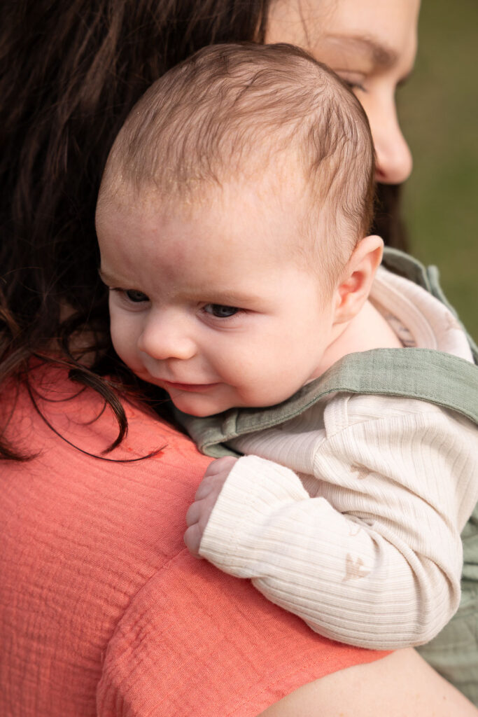3-month-old baby boy is held by his mom during Raleigh baby photo session