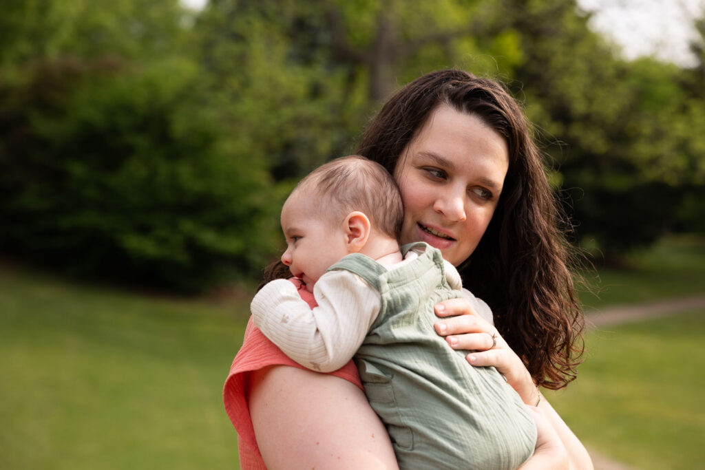 Mom's holds her 3-month-old son during a baby milestone photo session at Fred Fletcher Park in Raleigh, NC
