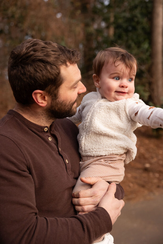Dad and 1-year-old son in golden light at Lake Johnson Raleigh family photo session