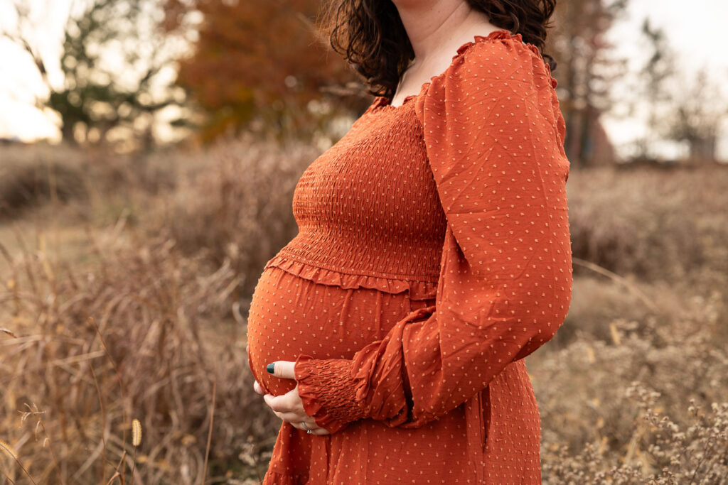 Close-up side view of mom's baby belly