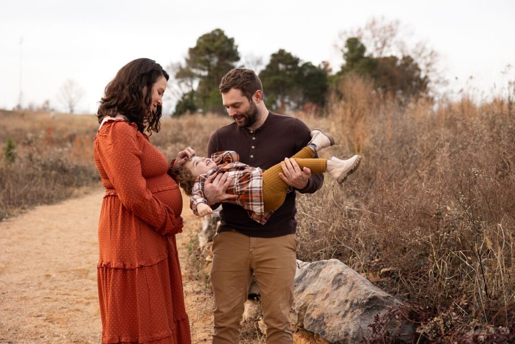 Family of 3 Raleigh maternity photo session playing with toddler