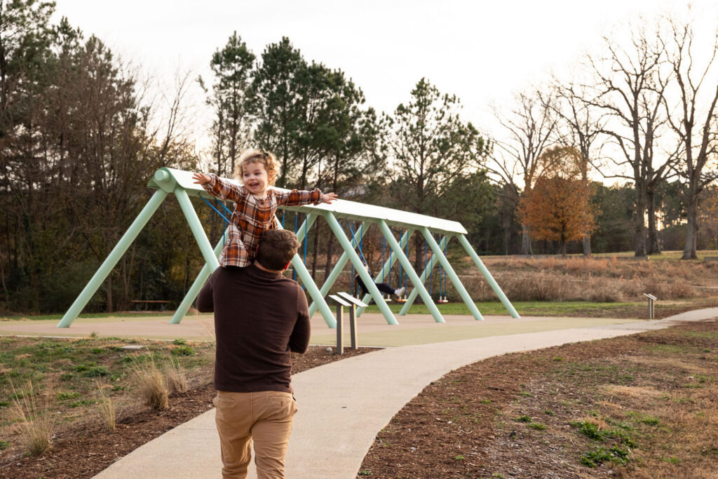 Raleigh family photos at NCMA with musical swings
