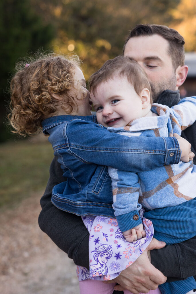 Prairie Ridge Ecostation family photo session, dad holds daughter and son