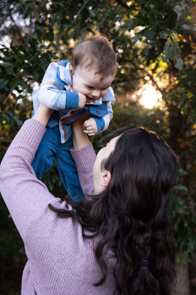 Mom holds baby boy up during Prairie Ridge Ecostation family photo session