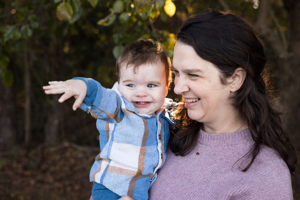 Mom and baby son off-camera while smiling big at Prairie Ridge Ecostation 